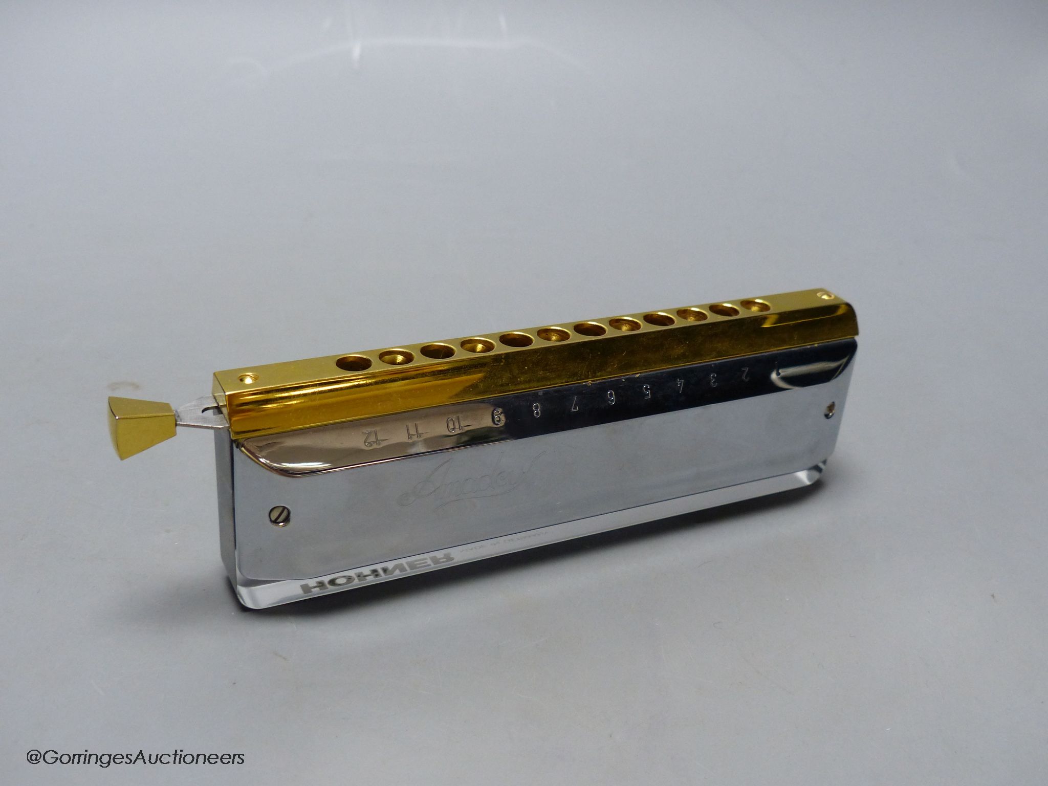 An M.Hohner Amadeus cased harmonica